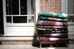 stock-photo-light-colorful-rug-rugs-for-sale-persian-bazzar-95b1c43a-844c-447c-aedd-8c7cf642b15f